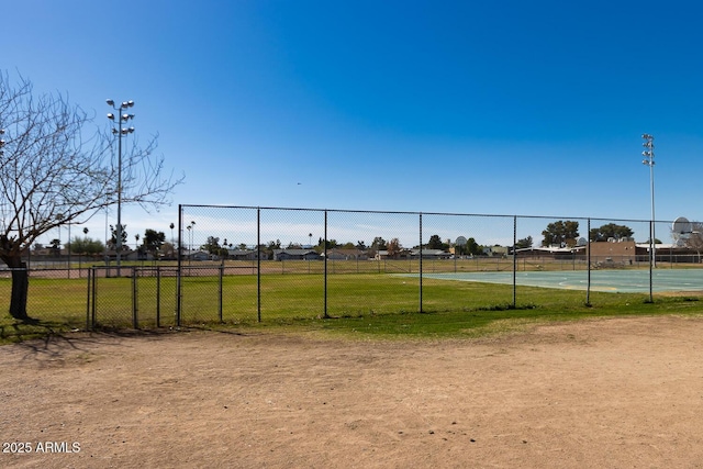 view of home's community featuring fence and a lawn