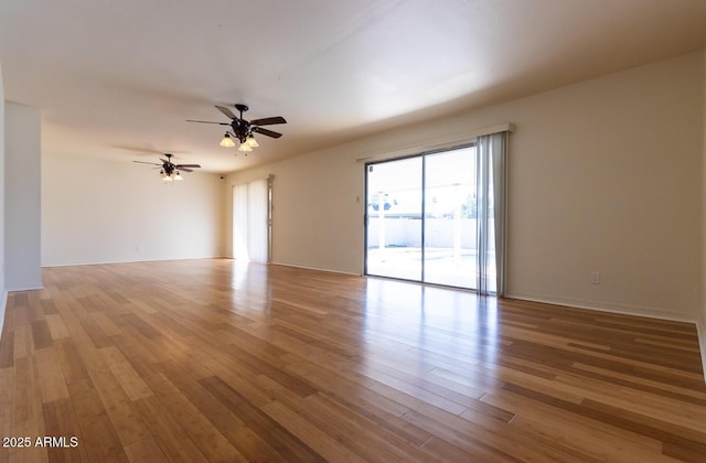 empty room with ceiling fan and wood finished floors