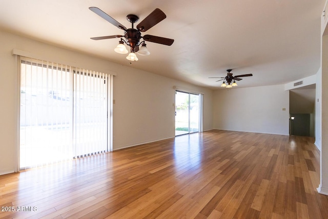 unfurnished living room featuring visible vents, light wood-style floors, and ceiling fan