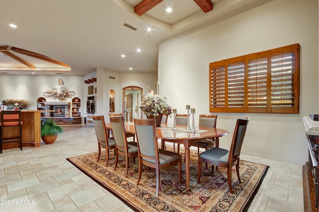 dining space featuring beamed ceiling