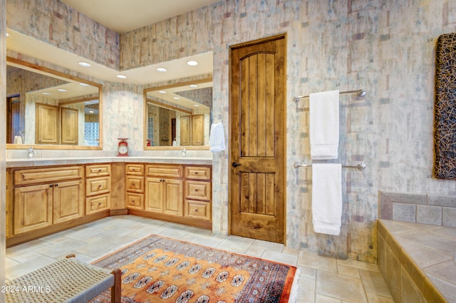 bathroom featuring a tub to relax in and vanity