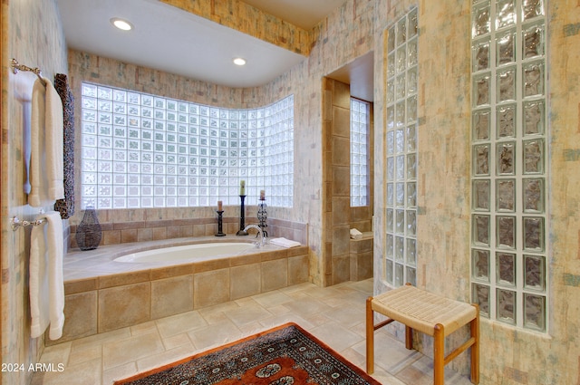 bathroom with tile walls and a tile shower