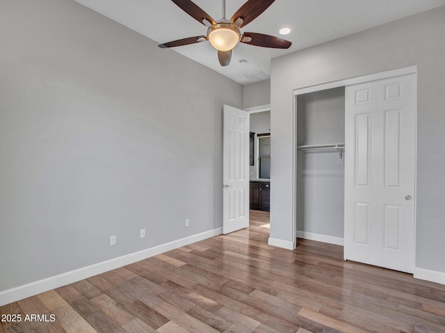 3809 E Lynx Pl, Chandler, AZ 85249 - unfurnished bedroom featuring wood finished floors, baseboards, a closet, and a ceiling fan