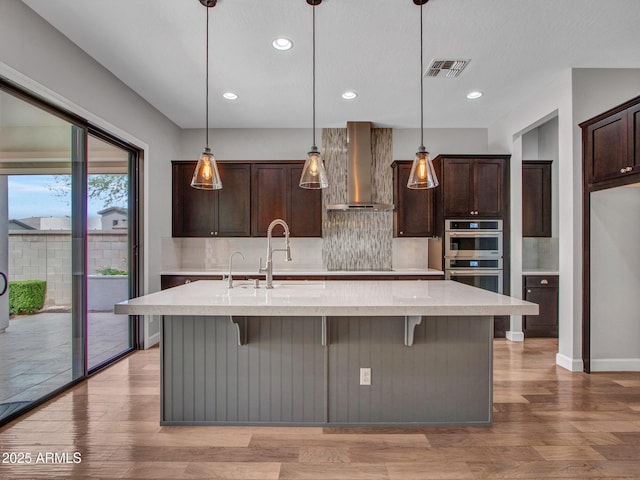3809 E Lynx Pl, Chandler, AZ 85249 - kitchen with wall chimney range hood, stainless steel double oven, a sink, backsplash, and dark brown cabinets