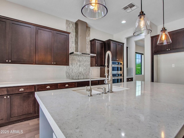 3809 E Lynx Pl, Chandler, AZ 85249 - kitchen featuring wall chimney range hood, double oven, decorative backsplash, pendant lighting, and recessed lighting