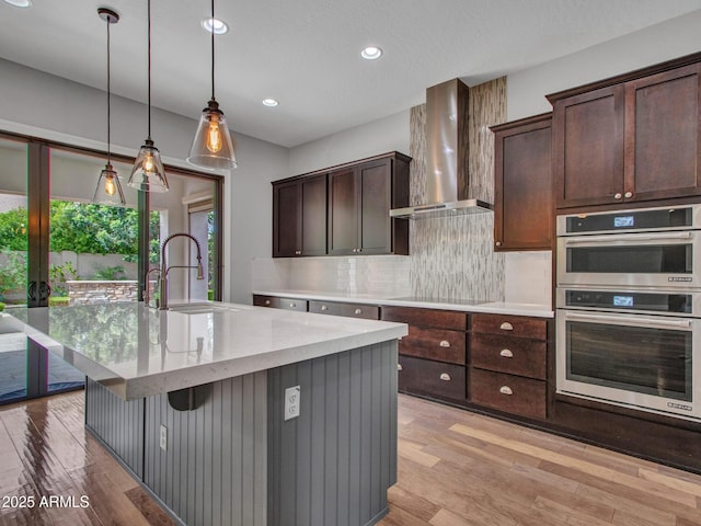 3809 E Lynx Pl, Chandler, AZ 85249 - kitchen featuring wall chimney exhaust hood, stainless steel double oven, a sink, backsplash, and recessed lighting