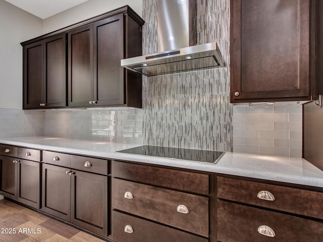 3809 E Lynx Pl, Chandler, AZ 85249 - kitchen with wall chimney range hood, dark brown cabinetry, tasteful backsplash, black electric stovetop, and light stone countertops