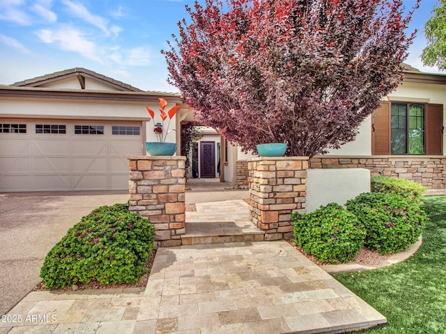3809 E Lynx Pl, Chandler, AZ 85249 - view of front facade featuring stucco siding, an attached garage, concrete driveway, and stone siding