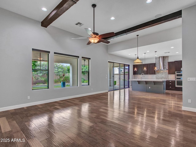 3809 E Lynx Pl, Chandler, AZ 85249 - unfurnished living room featuring beam ceiling, a sink, baseboards, dark wood-type flooring, and a ceiling fan