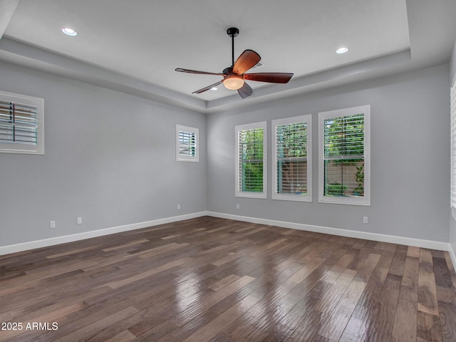 3809 E Lynx Pl, Chandler, AZ 85249 - empty room featuring a tray ceiling, wood-type flooring, ceiling fan, baseboards, and recessed lighting