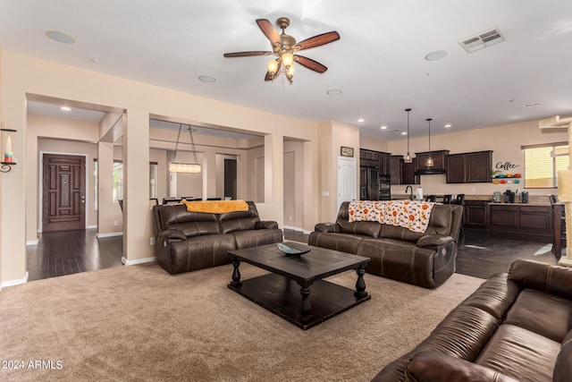 living room with ceiling fan and dark hardwood / wood-style flooring