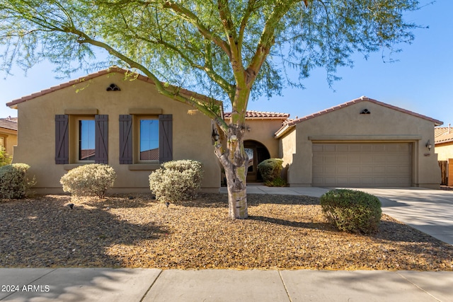 mediterranean / spanish-style home with a garage