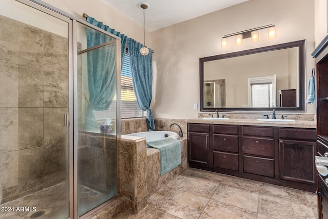 bathroom with vanity and separate shower and tub