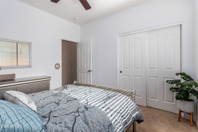 carpeted bedroom featuring a closet and ceiling fan