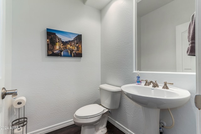 bathroom featuring toilet and hardwood / wood-style floors