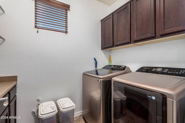 laundry room with independent washer and dryer and cabinets