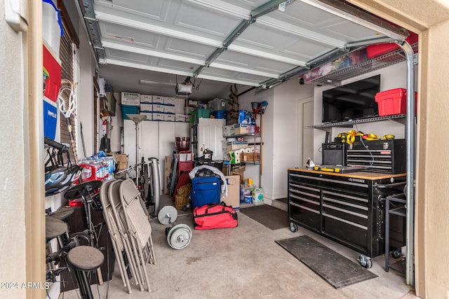 garage with a garage door opener and a workshop area