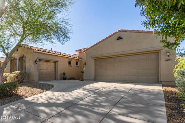 mediterranean / spanish-style home with a garage