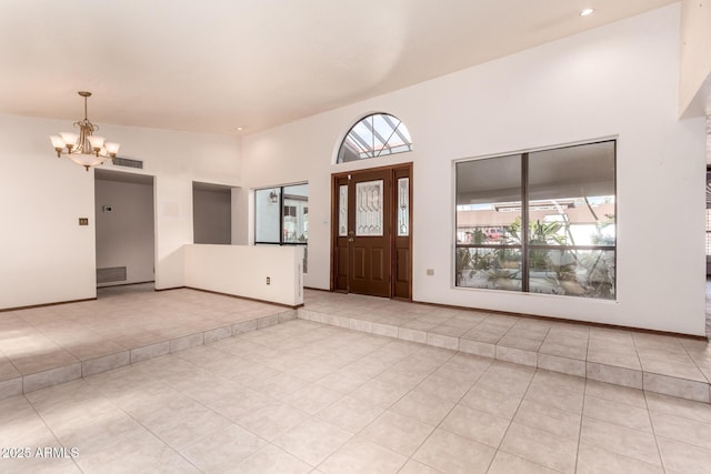 foyer featuring light tile patterned flooring and a chandelier