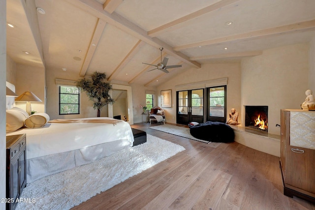 bedroom with vaulted ceiling with beams, light wood-type flooring, french doors, and multiple windows