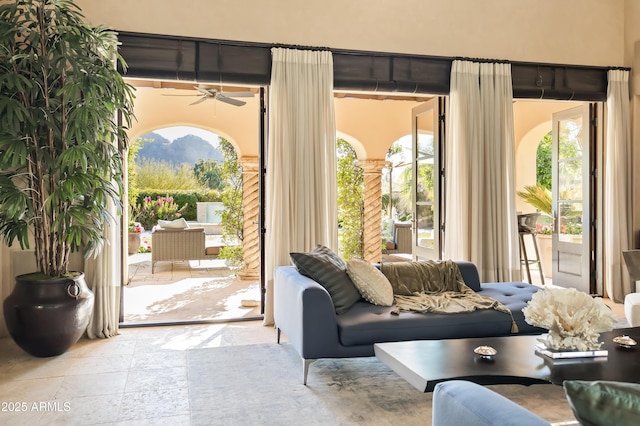 doorway to outside featuring ceiling fan and plenty of natural light