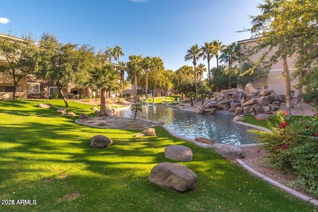 5345 E Van Buren St Unit 115, Phoenix, AZ 85008 - view of community featuring a yard and a garden pond