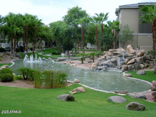 5345 E Van Buren St Unit 115, Phoenix, AZ 85008 - view of community featuring a yard and a garden pond