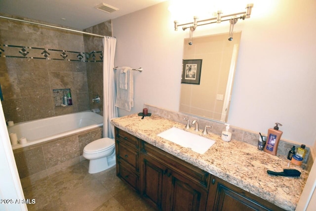 5345 E Van Buren St Unit 115, Phoenix, AZ 85008 - bathroom featuring vanity, tiled shower / bath, toilet, and tile patterned floors