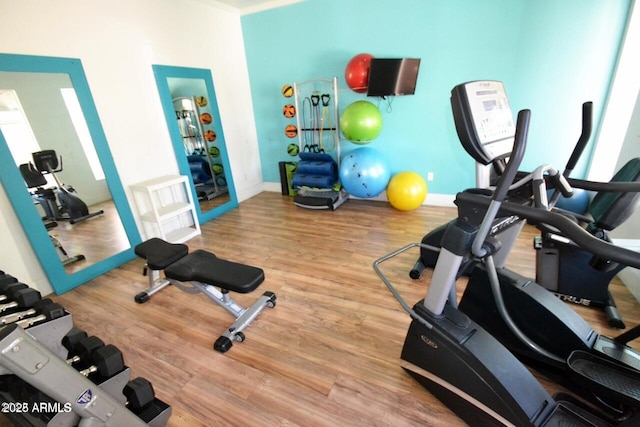5345 E Van Buren St Unit 115, Phoenix, AZ 85008 - workout area with wood finished floors and baseboards