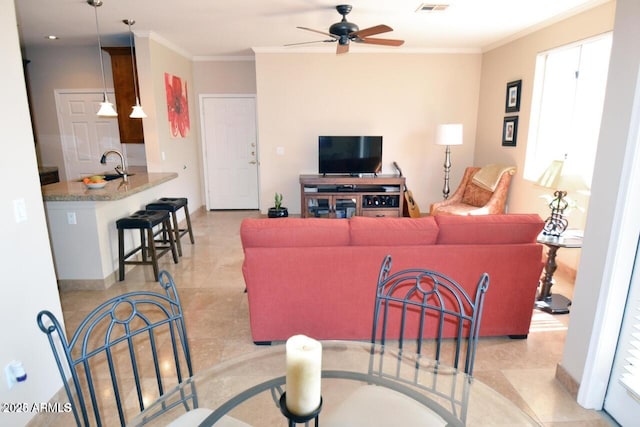 5345 E Van Buren St Unit 115, Phoenix, AZ 85008 - living room with ornamental molding, ceiling fan, and baseboards