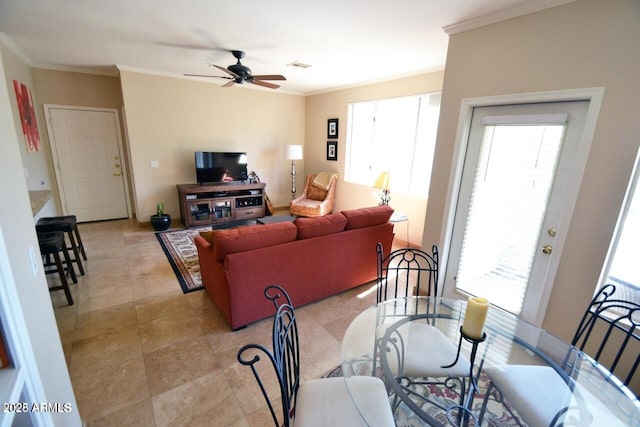 5345 E Van Buren St Unit 115, Phoenix, AZ 85008 - dining space featuring crown molding, plenty of natural light, a ceiling fan, and light tile patterned floors