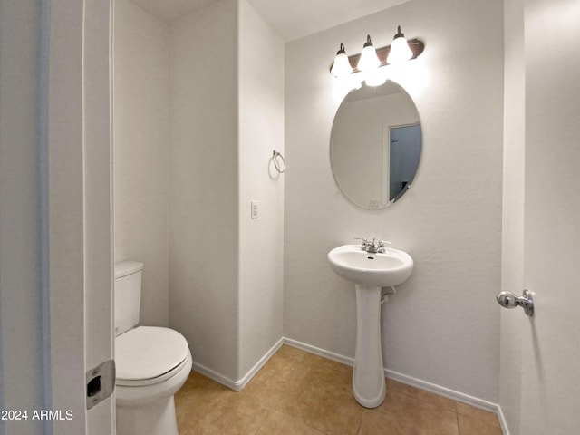 bathroom with tile patterned floors and toilet