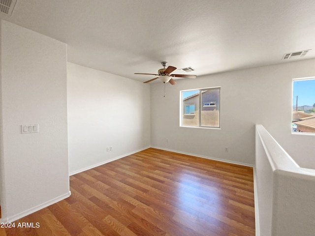 spare room featuring hardwood / wood-style floors and ceiling fan