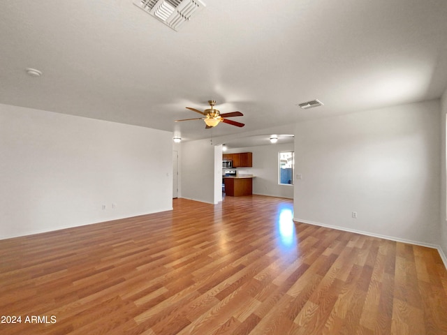 unfurnished living room with ceiling fan and light hardwood / wood-style flooring