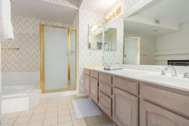 bathroom with tile patterned flooring, vanity, and shower with separate bathtub