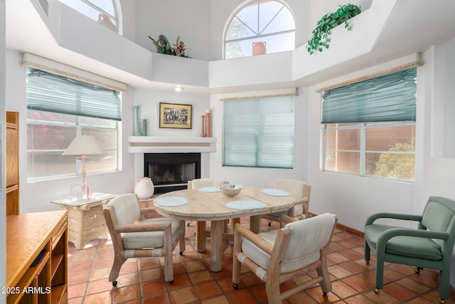 tiled dining room featuring a towering ceiling