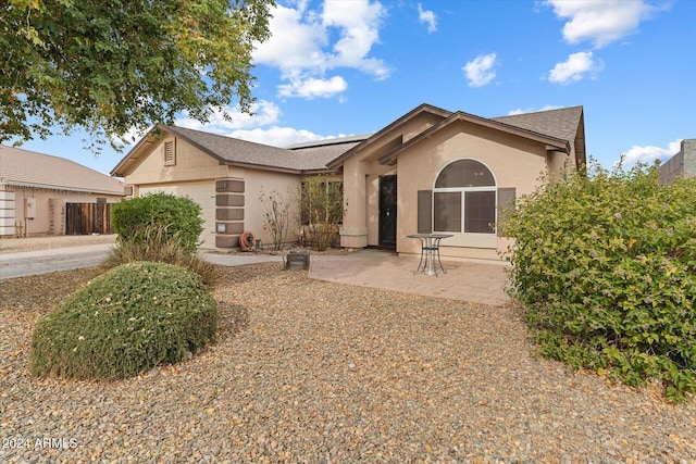 view of front of home featuring a garage and a patio area