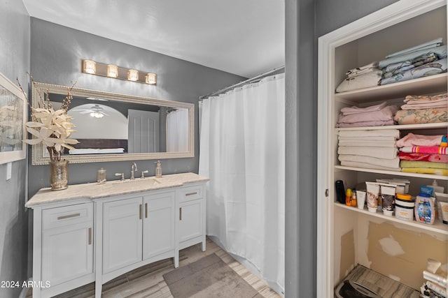 bathroom featuring vanity, a shower with shower curtain, and hardwood / wood-style flooring