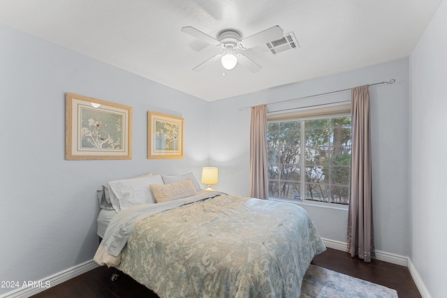 bedroom with ceiling fan and dark wood-type flooring