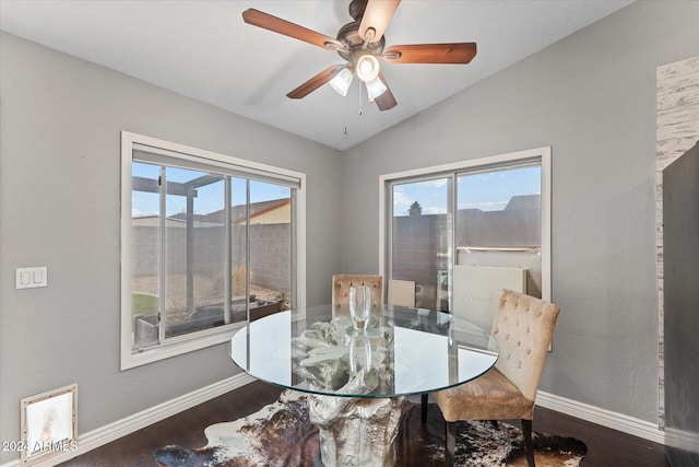 dining area with plenty of natural light, dark hardwood / wood-style flooring, and vaulted ceiling