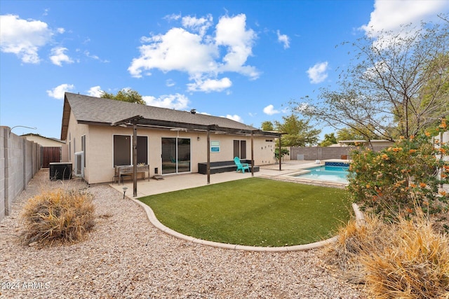 rear view of property with a patio area and a fenced in pool