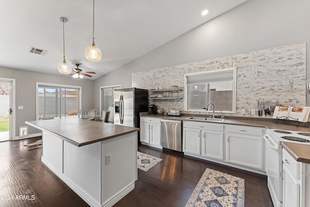 kitchen featuring stainless steel appliances, ceiling fan, sink, white cabinets, and a kitchen island