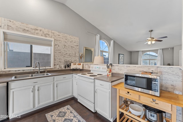 kitchen with white cabinets, sink, vaulted ceiling, ceiling fan, and appliances with stainless steel finishes