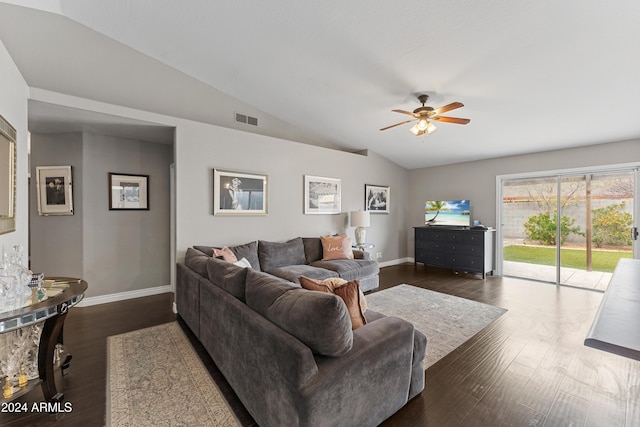 living room featuring dark hardwood / wood-style floors, vaulted ceiling, and ceiling fan