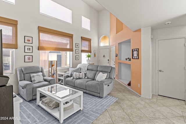 tiled living room with a towering ceiling