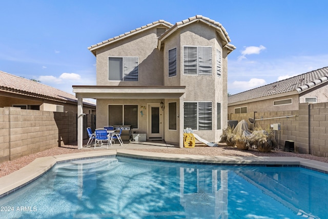 3211 E Kerry Ln, Phoenix, AZ 85050 - back of house featuring a fenced backyard, a fenced in pool, stucco siding, and a patio area
