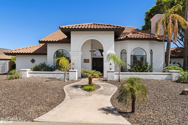 mediterranean / spanish-style house with a tile roof and stucco siding