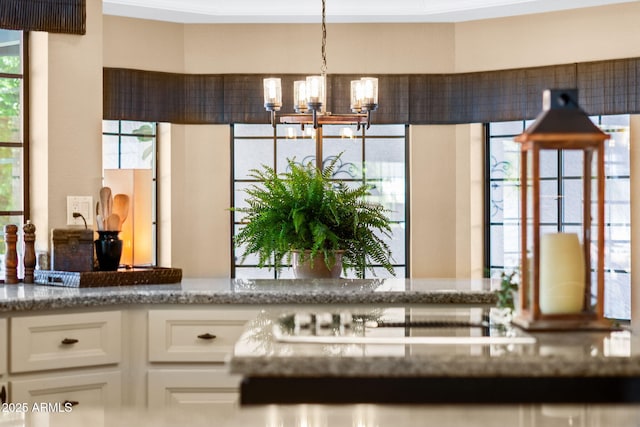 detailed view of a chandelier and cooktop
