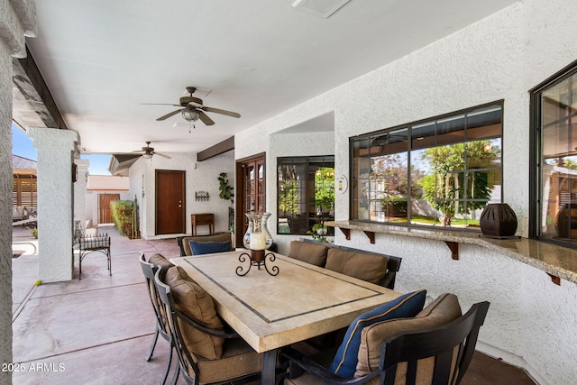 view of patio featuring a ceiling fan and outdoor dining area