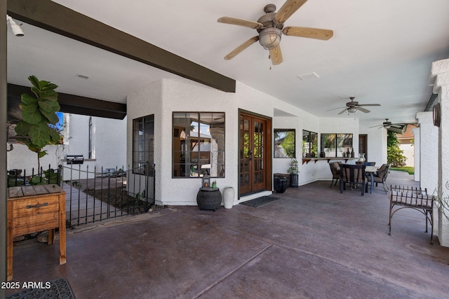 view of patio featuring french doors, a ceiling fan, and outdoor dining space